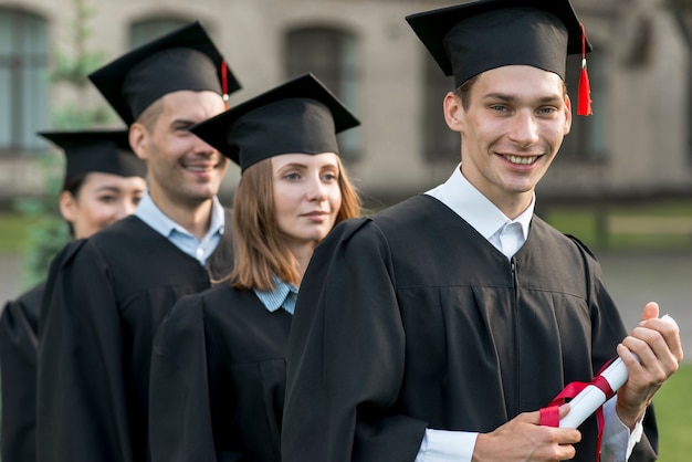 Free photo portrait of group of students celebrating their graduation