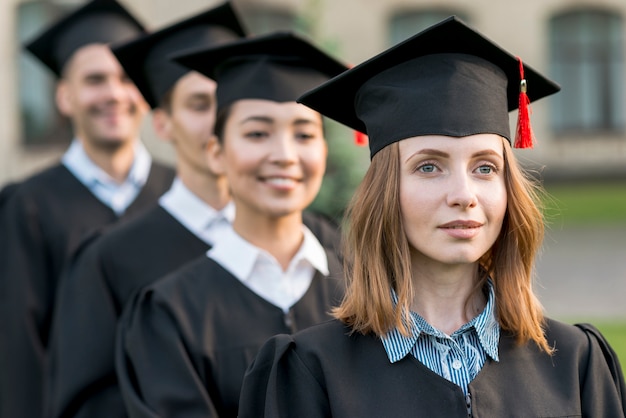 Free photo portrait of group of students celebrating their graduation