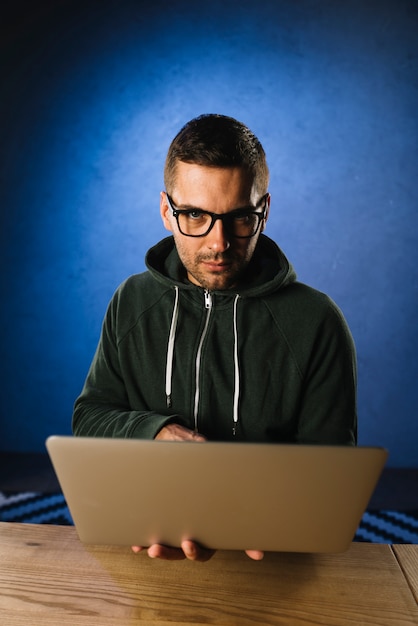 Free photo portrait of a hacker with laptop