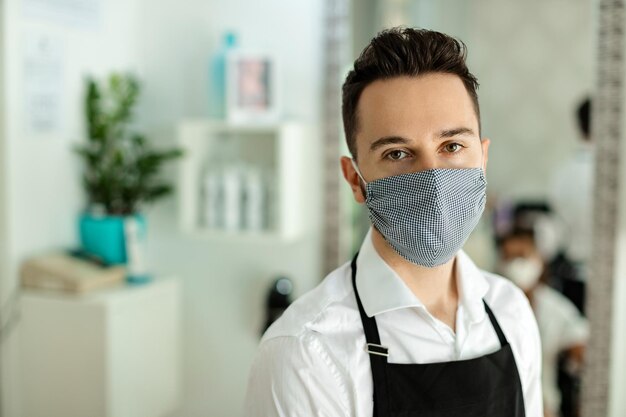 Portrait of hairstylist with protective face mask at hair salon