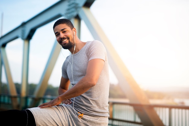 Portrait of handsome athlete preparing for training