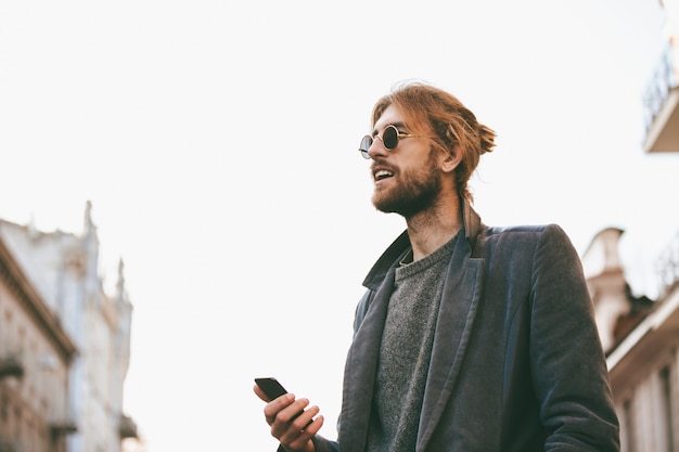 Portrait of a handsome bearded man in earphones