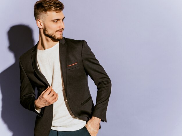 Portrait of handsome confident hipster  businessman model wearing casual black suit.