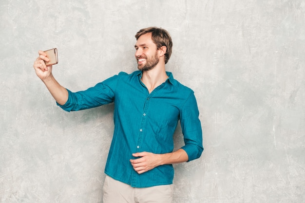 Portrait of handsome confident hipster lumbersexual businessman model wearing casual jeans shirt clothes. 