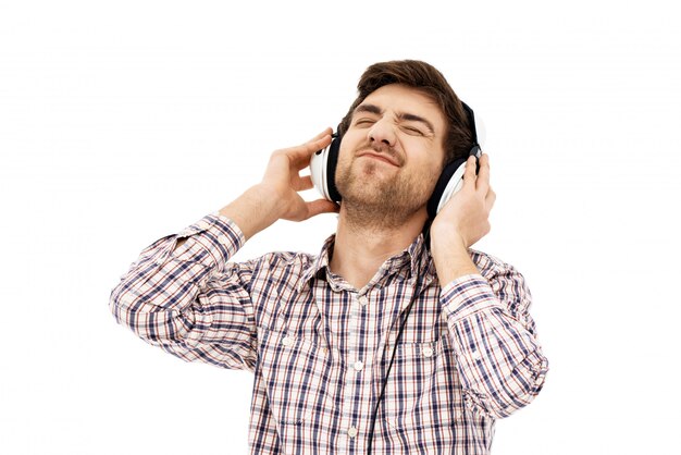 Portrait of a handsome confident man, singing in head phones