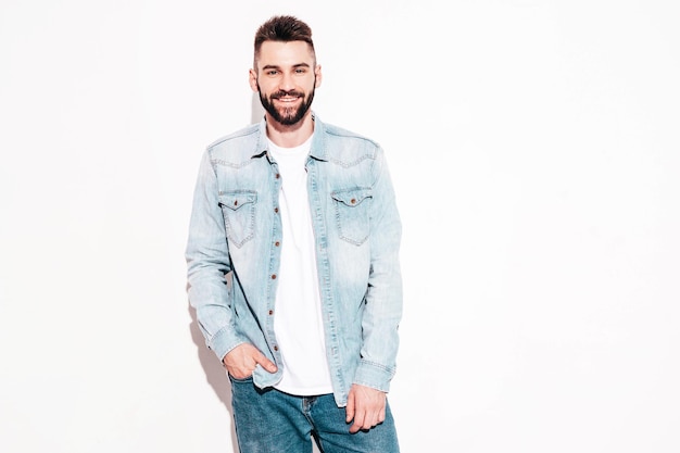 Portrait of handsome confident model Sexy stylish man Fashion hipster male posing near wall in studio Isolated