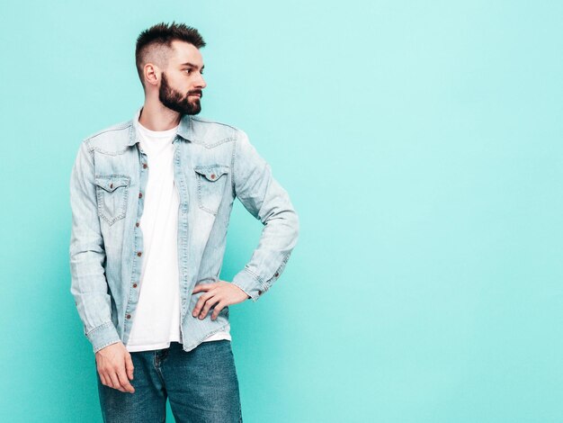 Portrait of handsome confident model Sexy stylish man Fashion hipster male posing near wall in studio