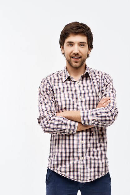 Portrait of handsome confident young man with crossed hands