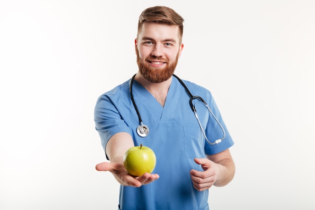 Portrait of handsome doctor in blue coat looking at camera