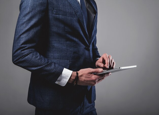 Portrait of handsome fashion businessman model dressed in elegant blue suit