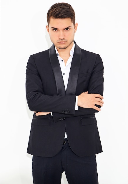 portrait of handsome fashion stylish hipster  businessman model dressed in elegant black classic suit