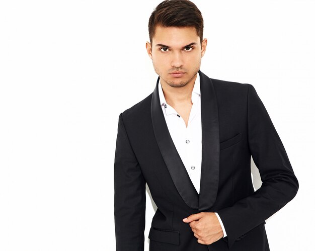 portrait of handsome fashion stylish hipster  businessman model dressed in elegant black classic suit 