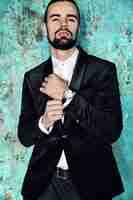 Free photo portrait of handsome fashion stylish hipster businessman model dressed in elegant black suit