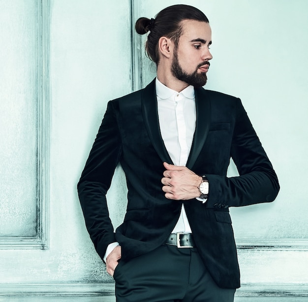 portrait of handsome fashion stylish hipster businessman model dressed in elegant black suit