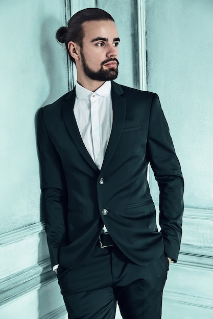 portrait of handsome fashion stylish hipster businessman model dressed in elegant black suit