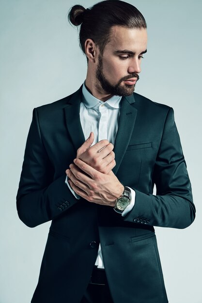 portrait of handsome fashion stylish hipster businessman model dressed in elegant black suit.