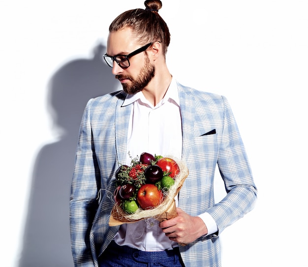 portrait of handsome fashion stylish hipster businessman model man dressed in elegant light blue suit in glasses on white