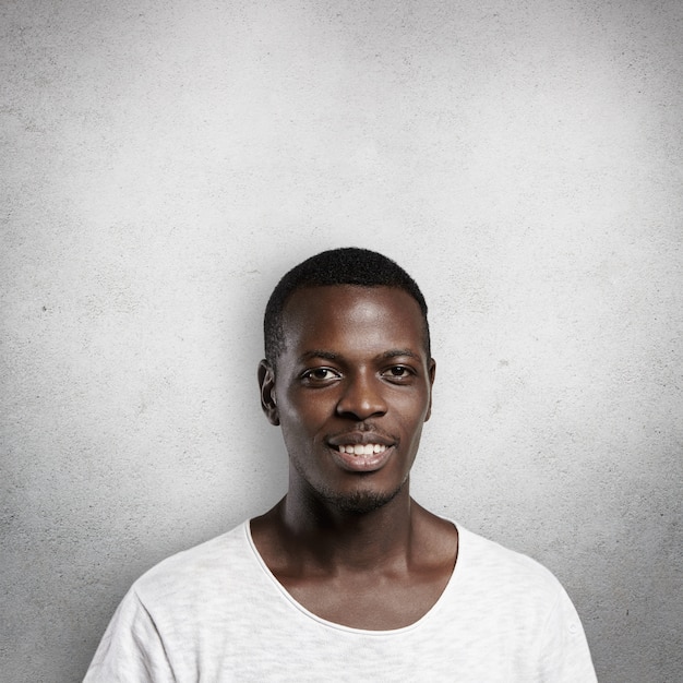 Portrait of handsome good-looking African man   with pleased expression.