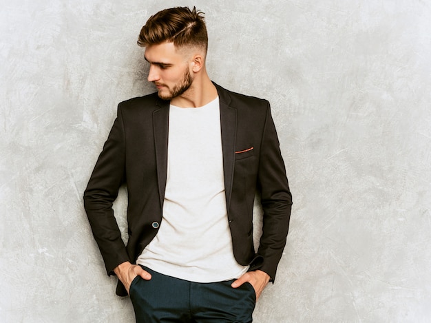 Portrait of handsome hipster   businessman model wearing casual black suit.