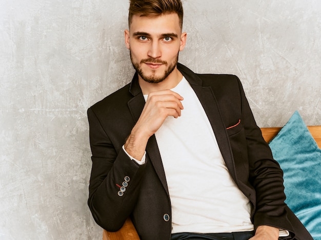 Portrait of handsome hipster   businessman model wearing casual black suit. 