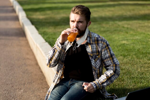 Free photo portrait of handsome male drinking juice