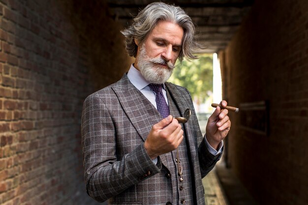 Portrait of handsome male posing with cigar