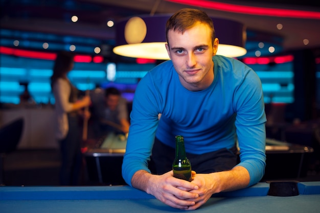 Free photo portrait of handsome man in billiard club