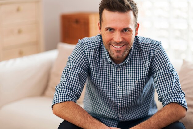 Portrait of handsome man in living room