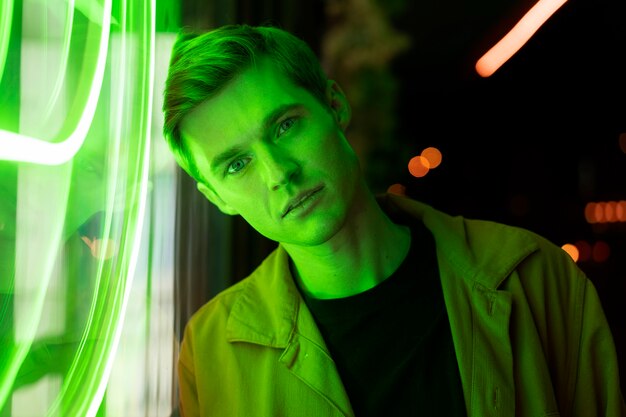 Portrait of a handsome man at night in neon light