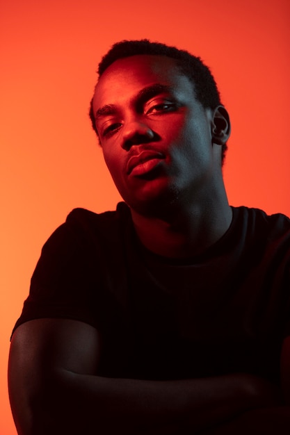 Portrait of handsome man over orange background