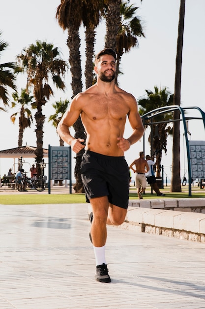 Free photo portrait of handsome man running routine