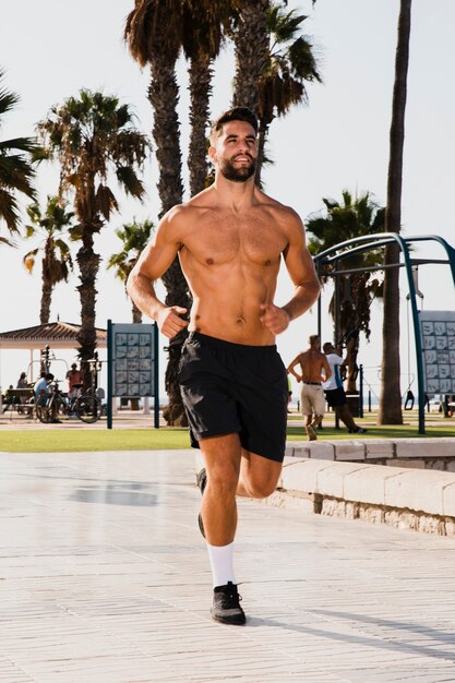 Portrait of handsome man running routine