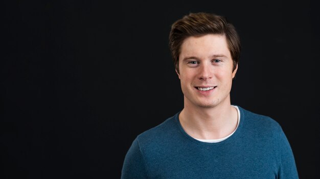 Portrait of handsome man in studio with copy space