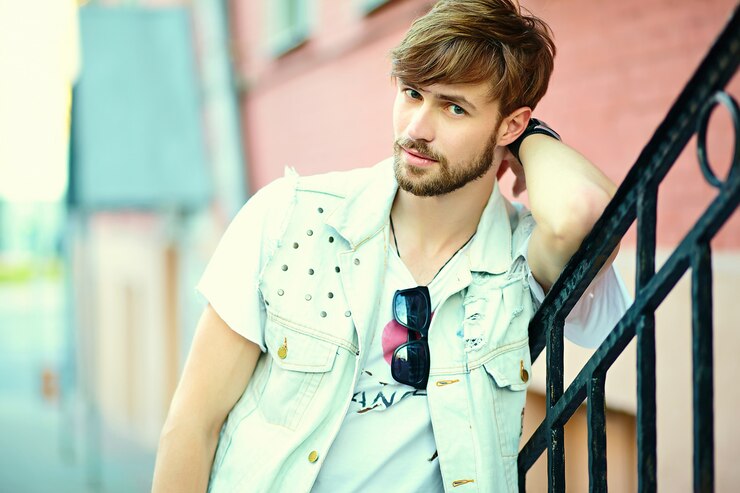Free Photo portrait of handsome man in stylish hipster clothes. attractive guy posing in the street