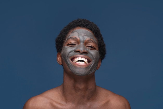 Portrait of a handsome man with charcoal mask on his face