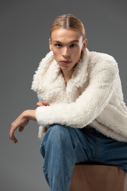 Portrait of handsome man with long blonde hair and fluffy jacket