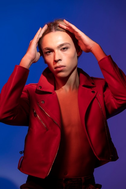 Portrait of handsome man with long blonde hair and red jacket