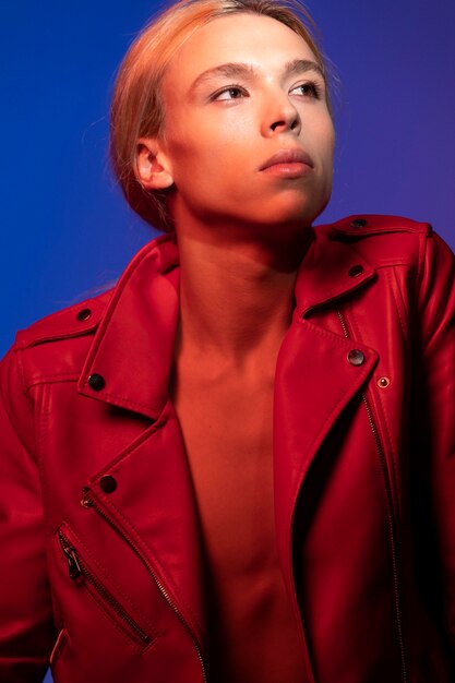 Portrait of handsome man with long blonde hair and red jacket