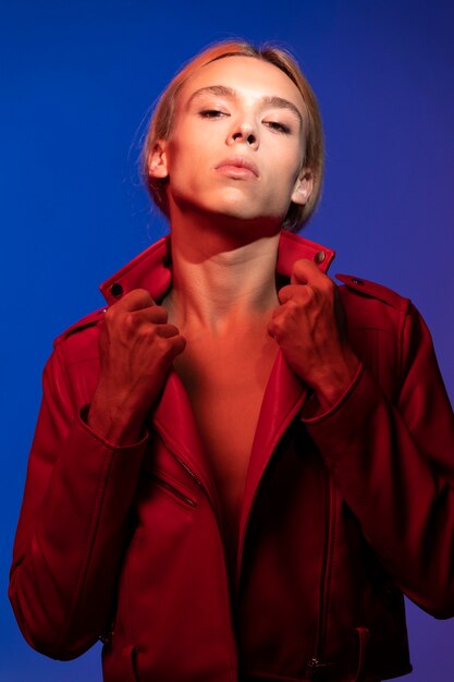 Portrait of handsome man with long blonde hair and red jacket