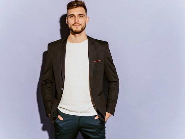 Portrait of handsome serious hipster  businessman model wearing casual black suit.