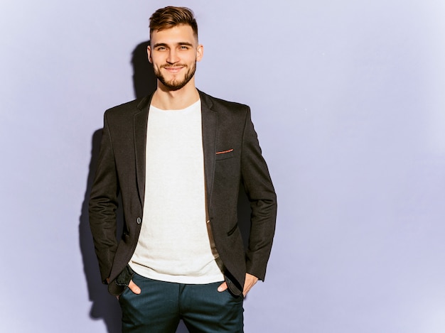 Free photo portrait of handsome smiling hipster  businessman model wearing casual black suit.