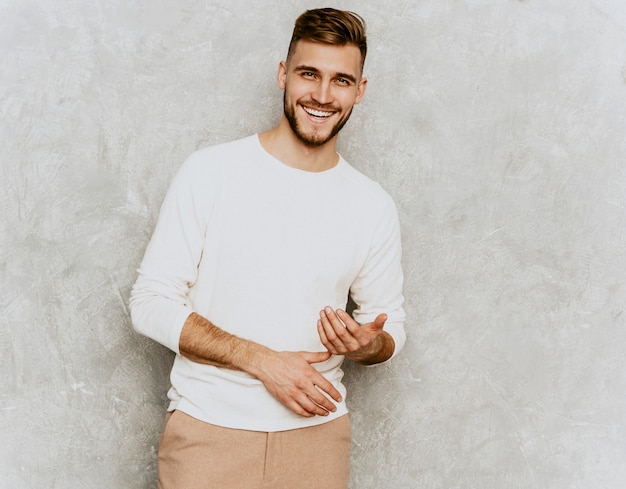 Portrait of handsome smiling hipster   businessman model wearing casual summer white clothes.