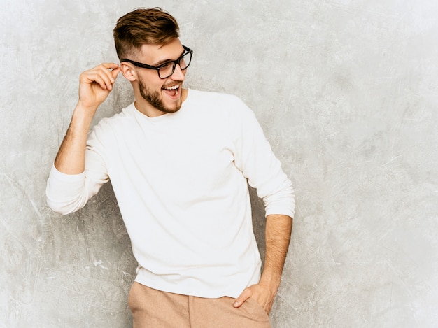 Portrait of handsome smiling hipster   businessman model wearing casual summer white clothes 