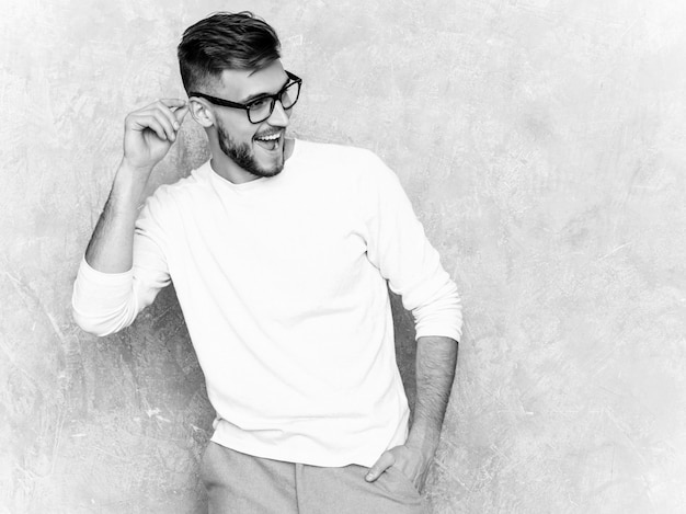Portrait of handsome smiling hipster   businessman model wearing casual summer white clothes 