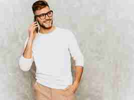 Free photo portrait of handsome smiling hipster   businessman model wearing casual summer white clothes.