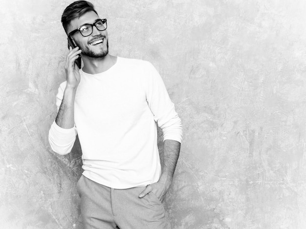 Portrait of handsome smiling hipster   businessman model wearing casual summer white clothes.