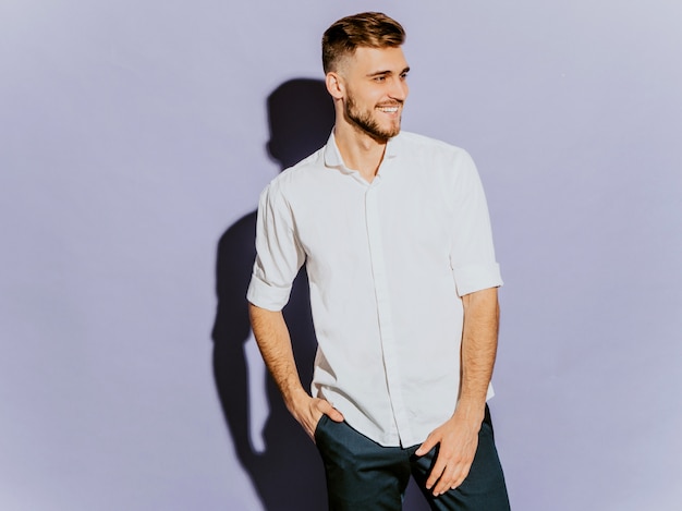 Free photo portrait of handsome smiling hipster  businessman model wearing casual summer white shirt.