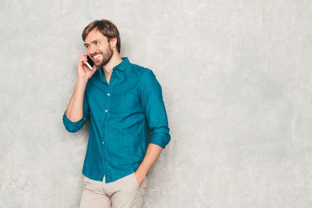 Portrait of handsome smiling hipster lumbersexual businessman model wearing casual jeans shirt clothes. 