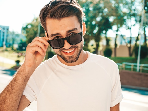 Portrait of handsome smiling stylish hipster lambersexual model