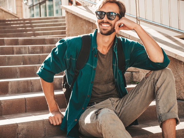 Portrait of handsome smiling stylish hipster lambersexual model